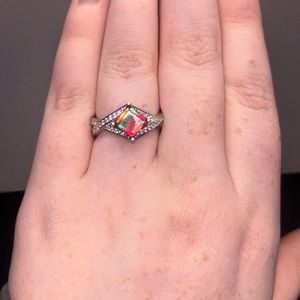 silver ring with red/green gem and smaller gems on side
